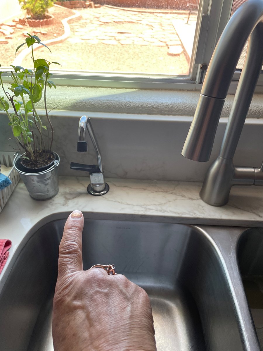 
A view of the kitchen sink with a small faucet that alkaline water is filtered for and to use for room temperature water. We also have a picture thats in the refrigerator with the same water.