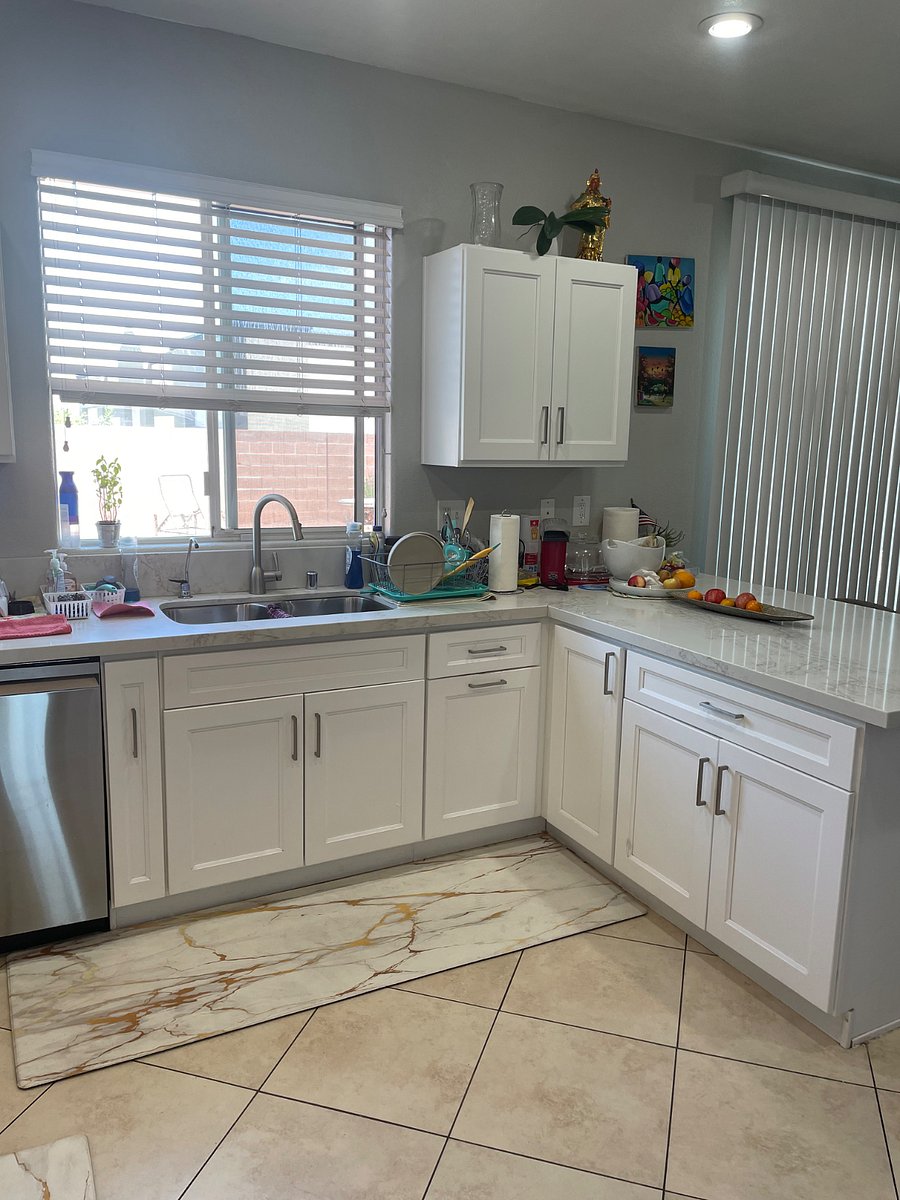 View of kitchen and view of the backyard from the kitchen sink. We have alkaline water thats next to our water faucet over the sink.