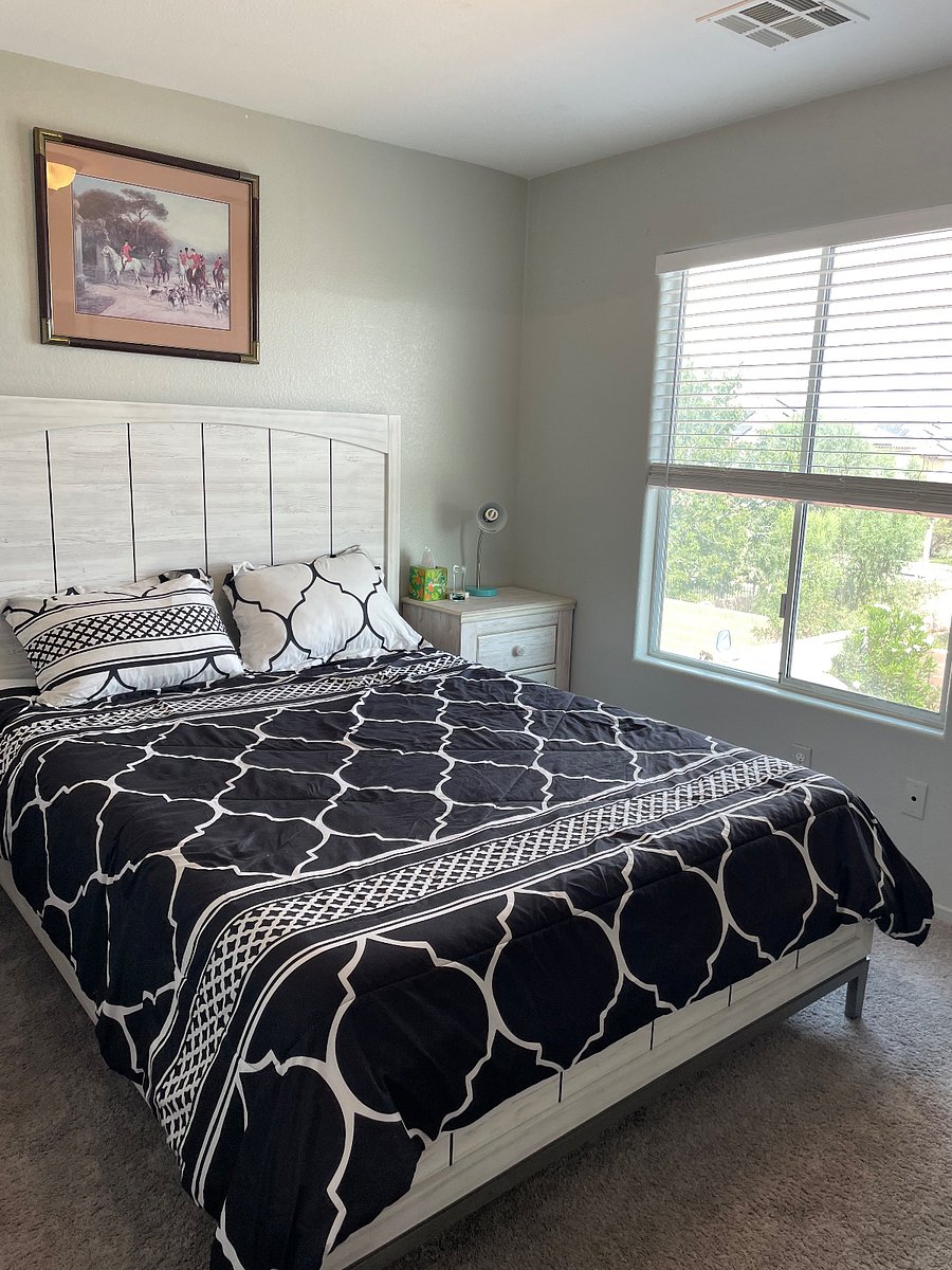 Another view of bedroom number five and front entrance of house also has smart television and closet