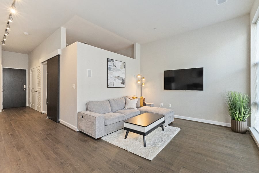 Living room with smart TV and additional laptop workspace with a lift-top console.