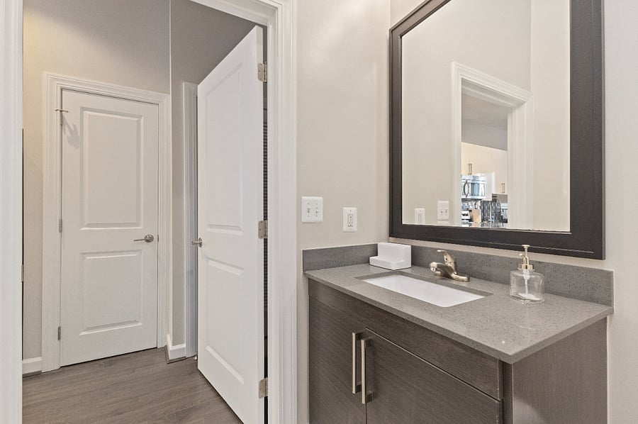 Large bathroom, equipped with sets of towels and starter items (toilet paper, travel size shampoo/conditioner, hand soap).