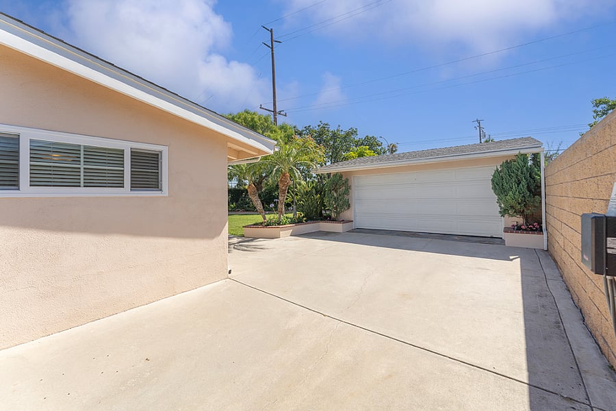 Driveway approach to the two-car garage with keypad and remote controlled garage door opener 