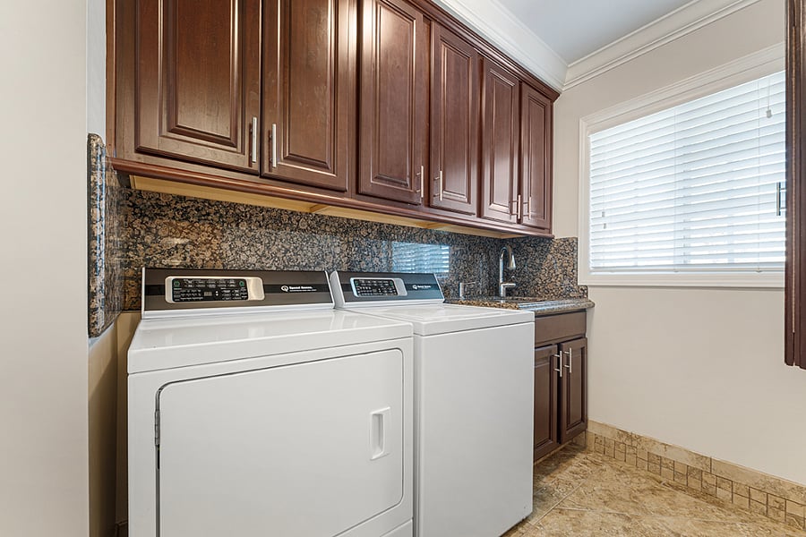 Laundry room - equipped with washer, dryer, laundry sink, and drop-down ironing board and iron 