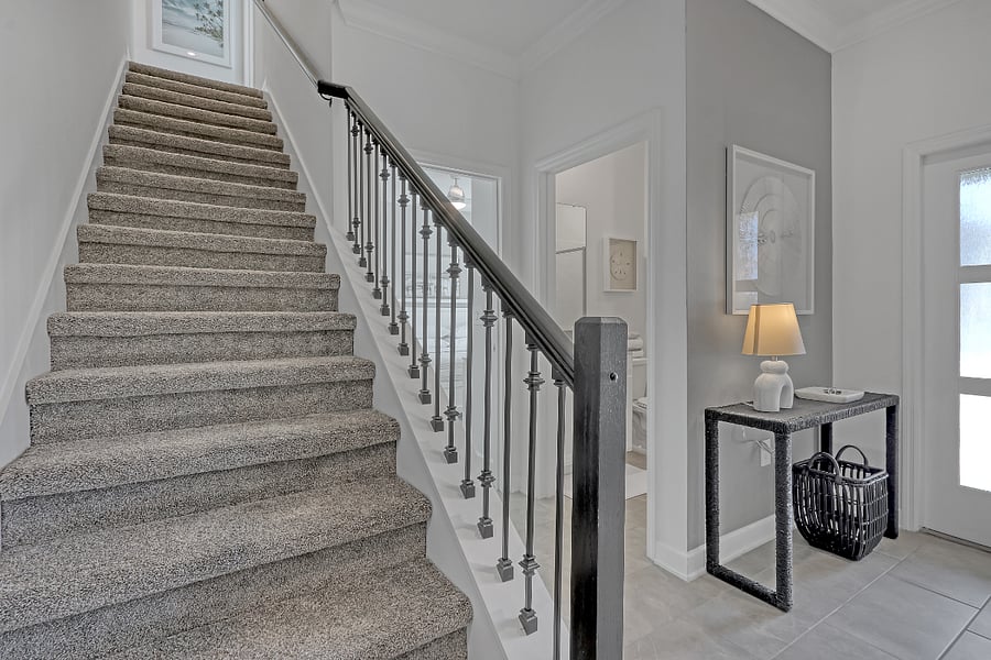 Stairs with safety railing leading to three bedrooms, two bathrooms, and laundry closet. 