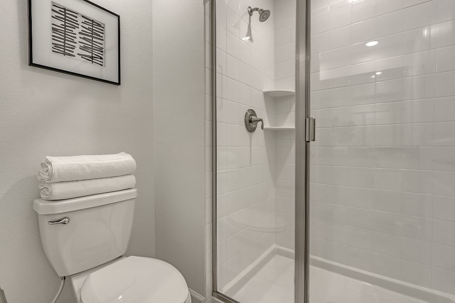 Guest bath with double sinks and separate shower room. 
