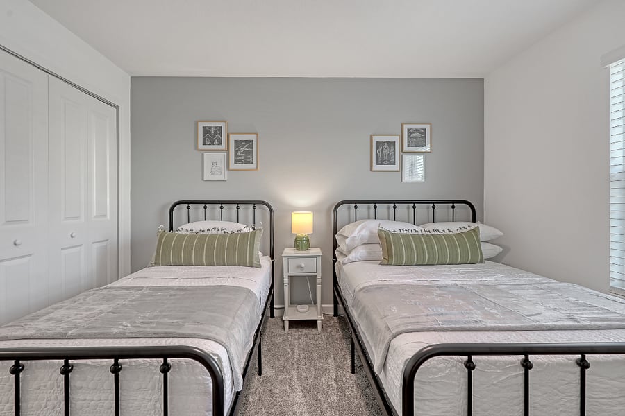 Twin & full beds with hotel-style linens and storage. 