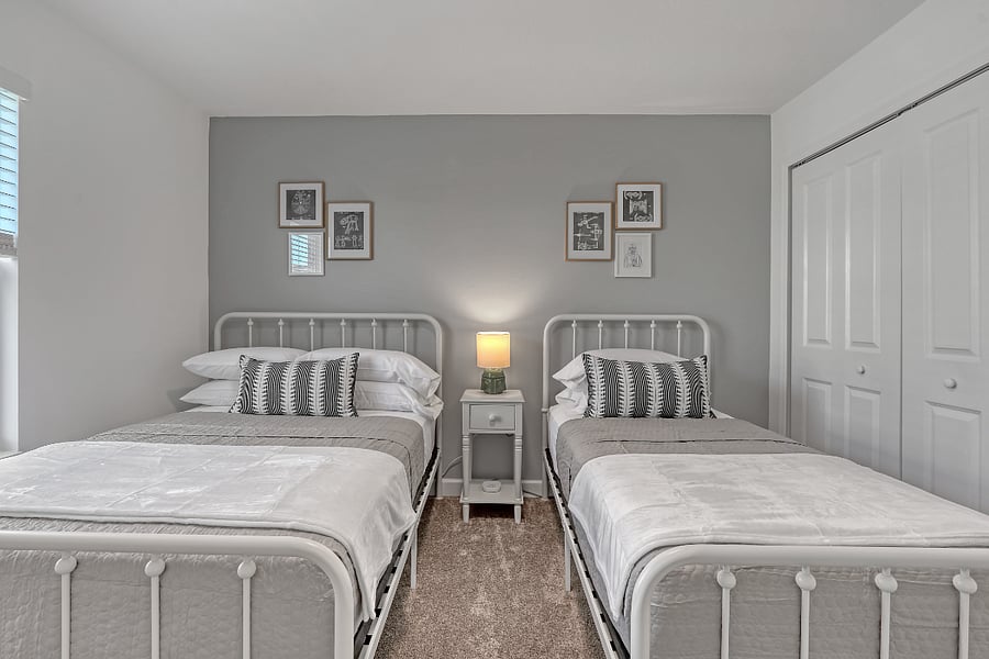 Twin & full beds with hotel-style linens and storage. 