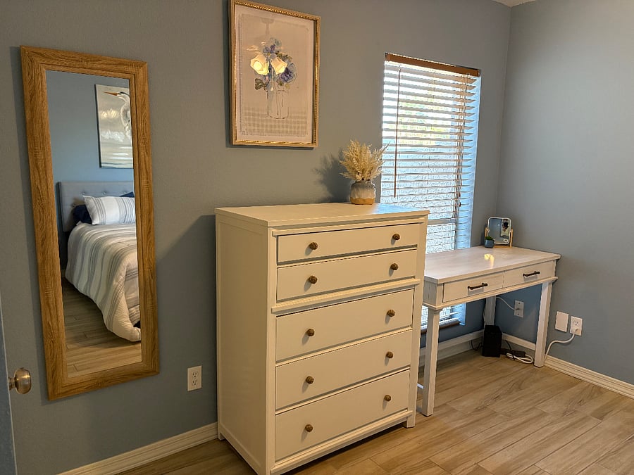 1st guest bedroom with queen bed and desk area