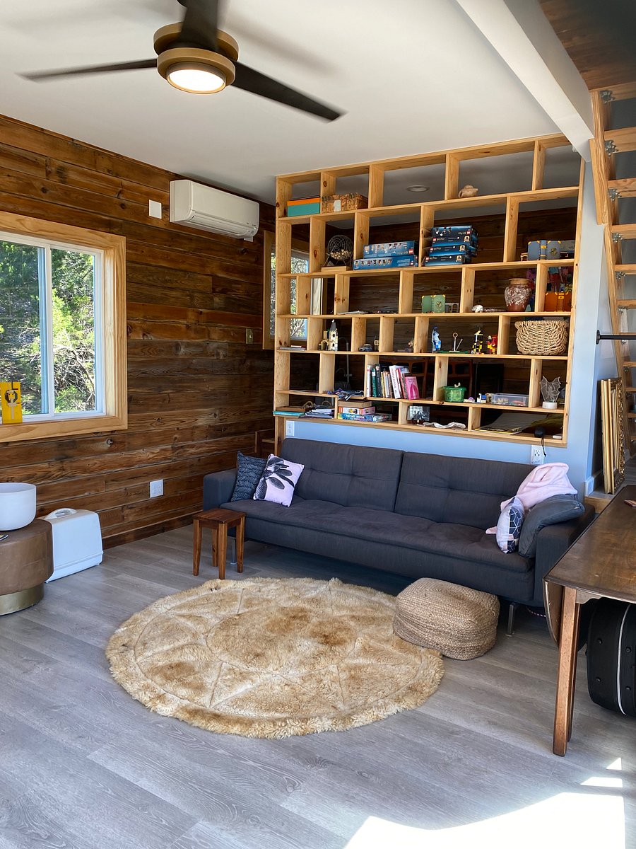 Living room. Couch folds out for twin sized bed. The room behind the bookshelf wall is a small bedroom/office
