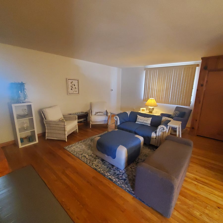 A cozy living room space where you can put your feet up, read a book or just watch t.v..