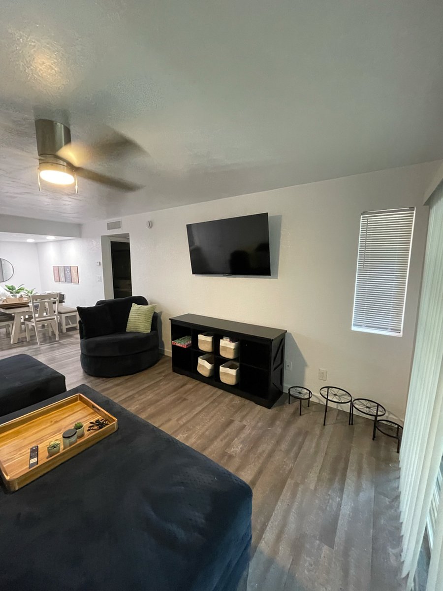 Comfy, cozy family room with plenty of seating, modern decor and mounted smart TV.