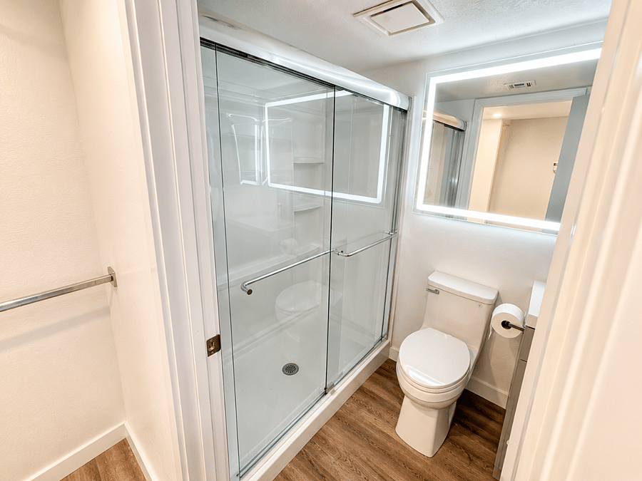 This second bedroom has a dedicated full bathroom nearby, making it easy for guests to enjoy their own routine.