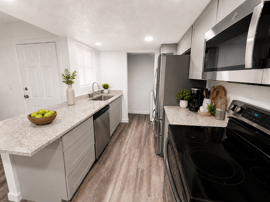 The fully stocked galley kitchen features brand new appliances and everything you need to prepare meals at home.