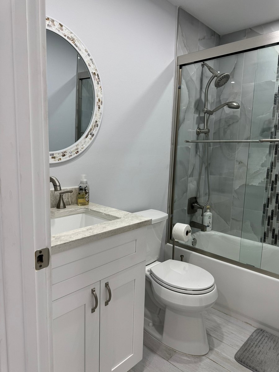 Guest bath has two access doors. One from the hall and the other private door from the bedroom.