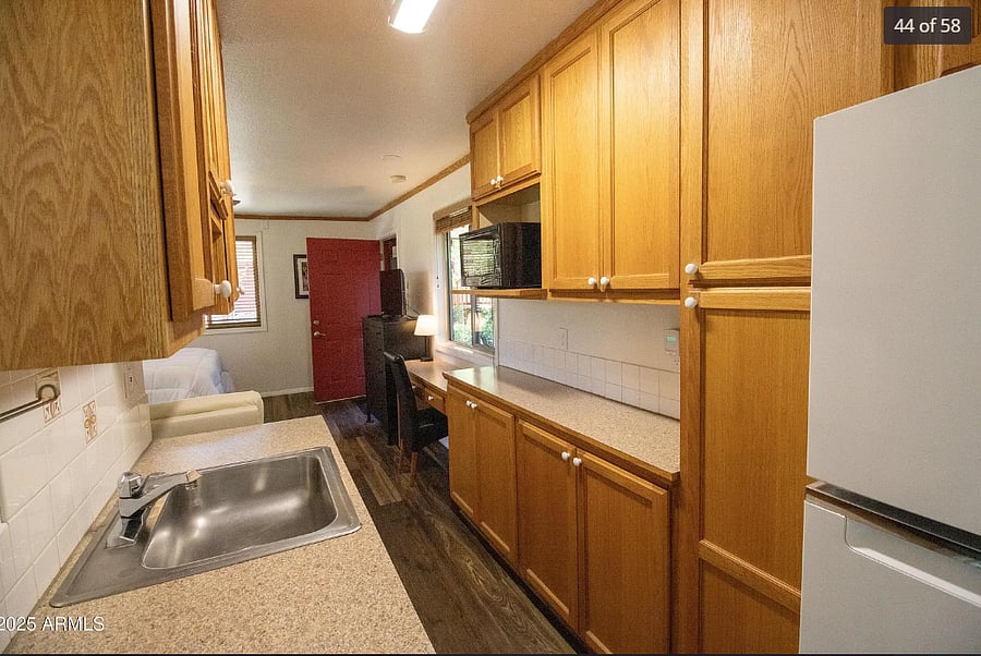 Kitchen area has a hot plate, electric convection oven w/rotisserie, Keurig coffee pot, electric kettle, full refrigerator and microwave.