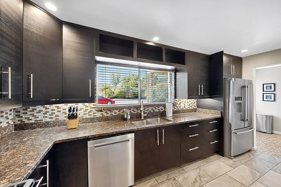Spacious kitchen with granite counters, upgraded appliances, lots of cabinet space, bar seating