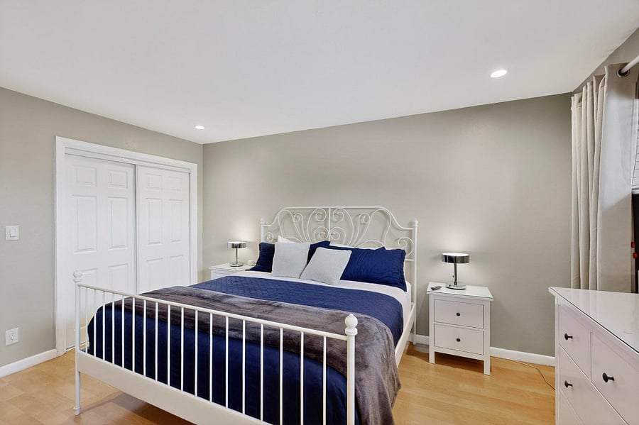 Primary bedroom with king bed, double closet, Smart TV, attached bathroom