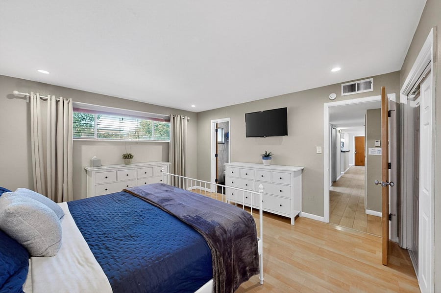 Primary bedroom with king bed, double closet, Smart TV, attached bathroom