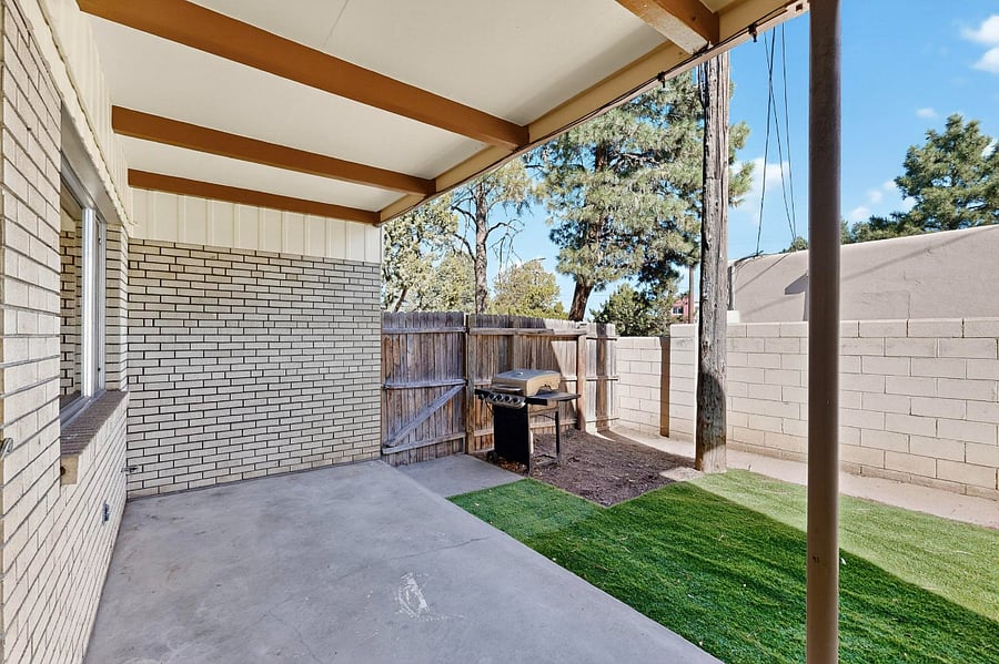 Backyard with patio, patio furniture, grill