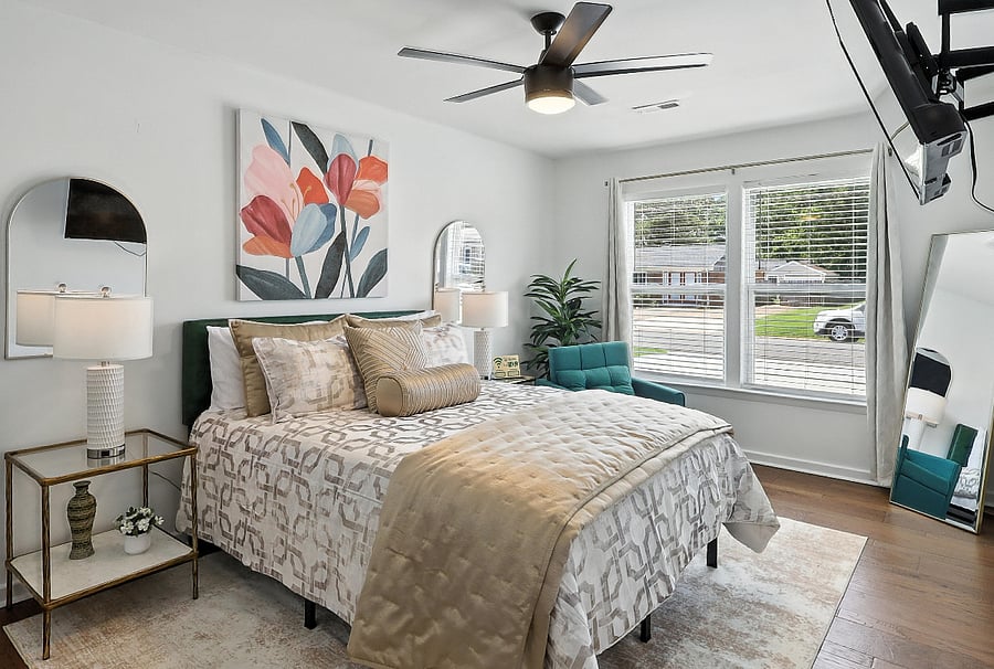 The primary suite offers an en-suite bath and large windows that fill the space with crisp morning light.