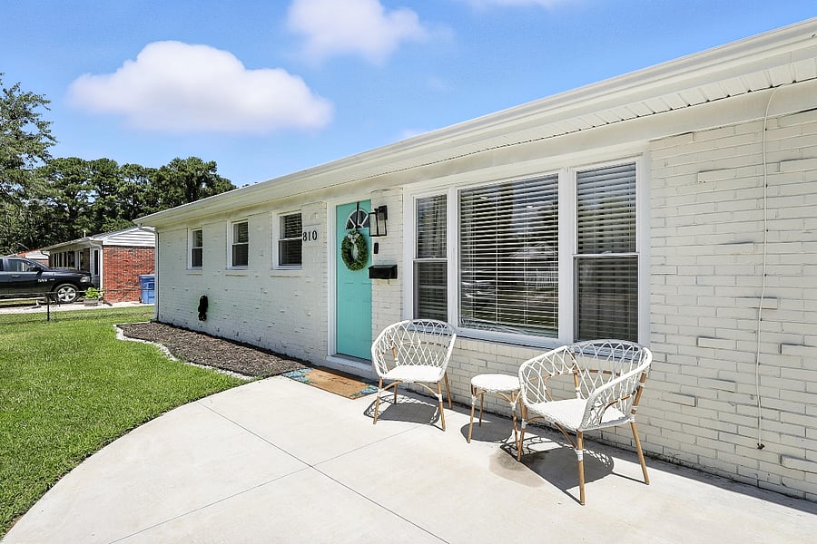 A modern exterior featuring a clean white finish and a bold splash of turquoise.