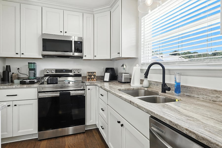 A modern kitchen with a microwave, stove, and dishwasher makes meal prep a breeze.