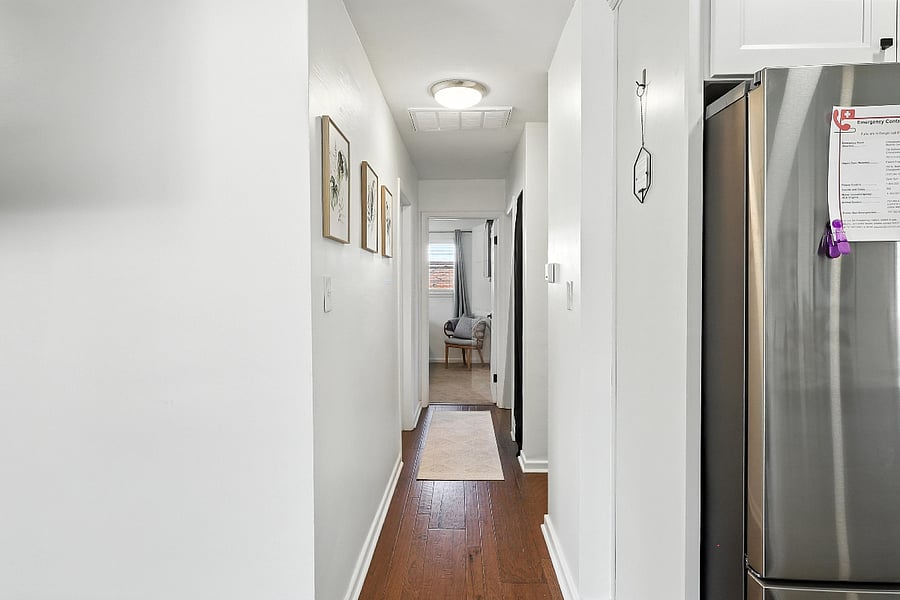 A well-lit hallway provides a clear connection between all rooms.