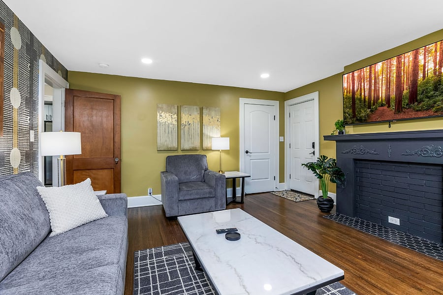 The living room includes a large closet for coats, plus there's an ironing board, extra bedding, broom/dustpan, and small vacuum.