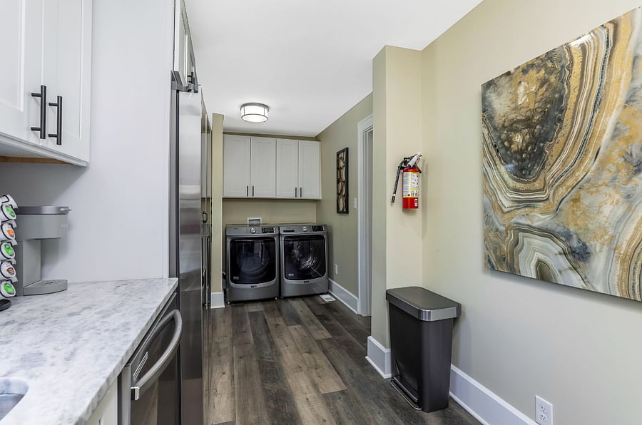 At the other end of the kitchen is a washer and dryer set that is new in 2025