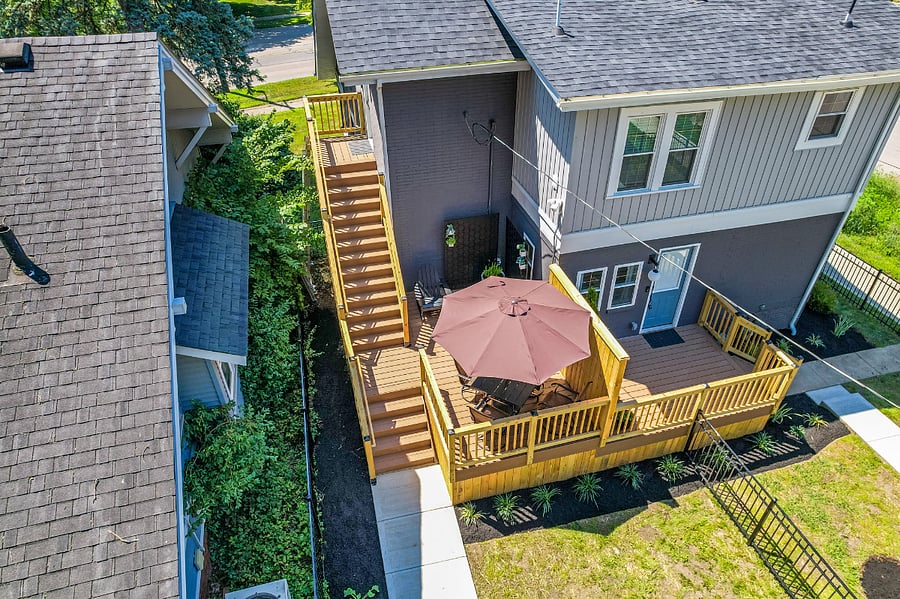 Aerial view of entrance, deck, and yard