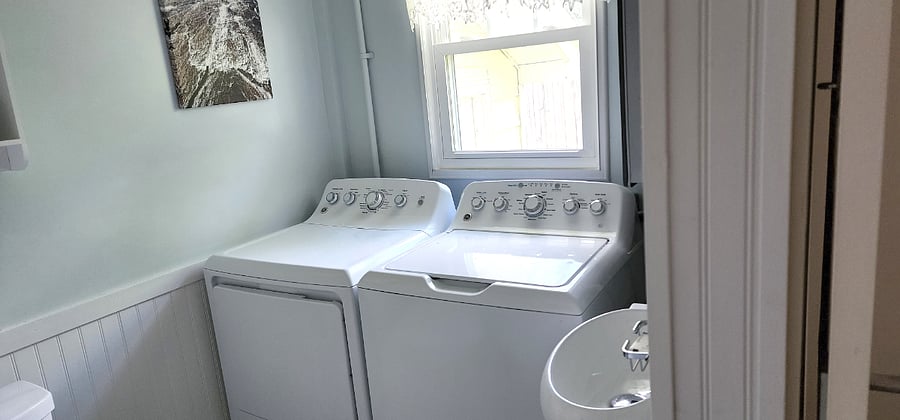 Half bath with full laundry overlooking backyard