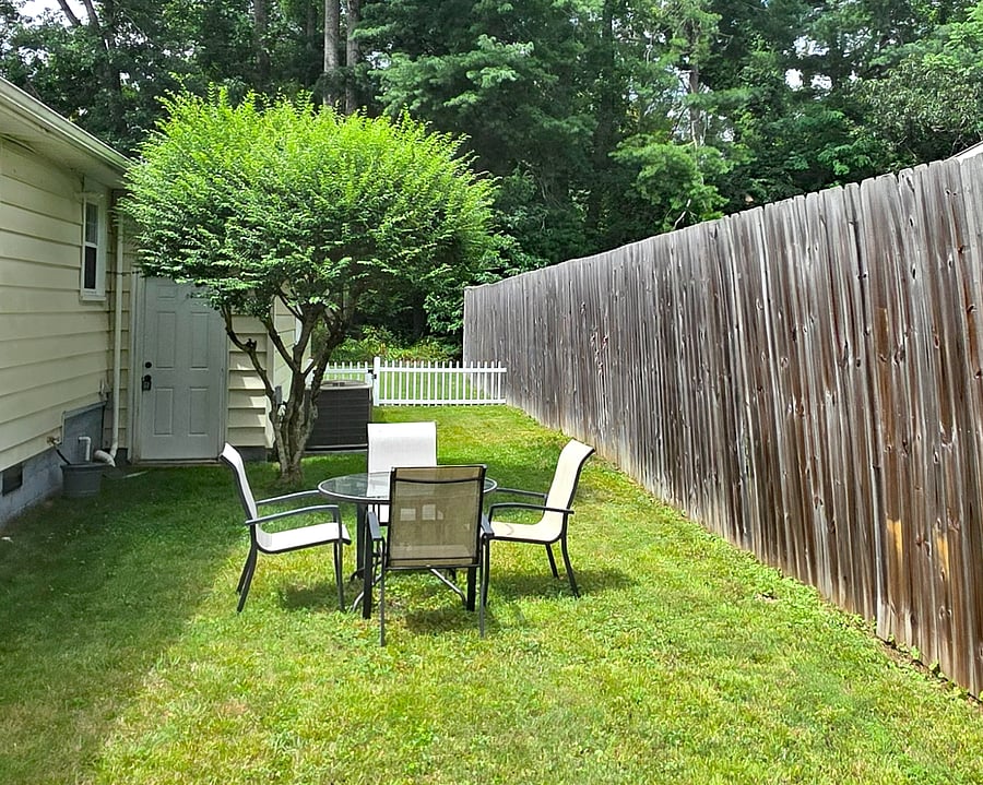 Backyard with view of adjacent wooded lot, part of the property