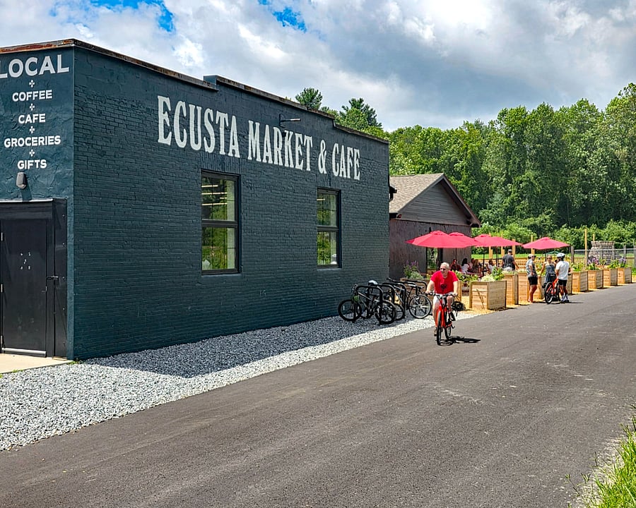 Exterior of Ecusta Market and Cafe, large outdoor seating area and small playground to the right