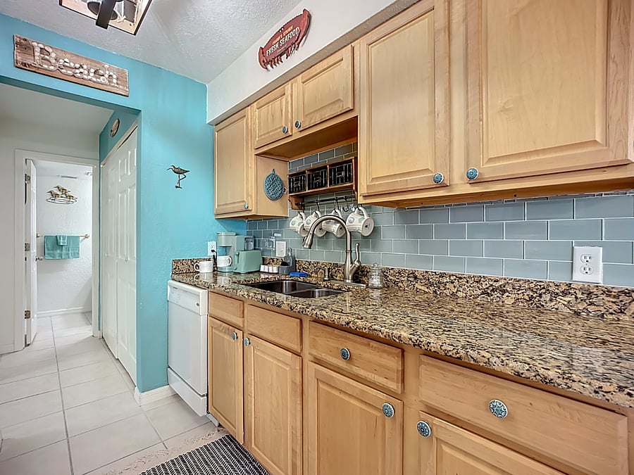 Another view of the kitchen showing dishwasher and coffee area