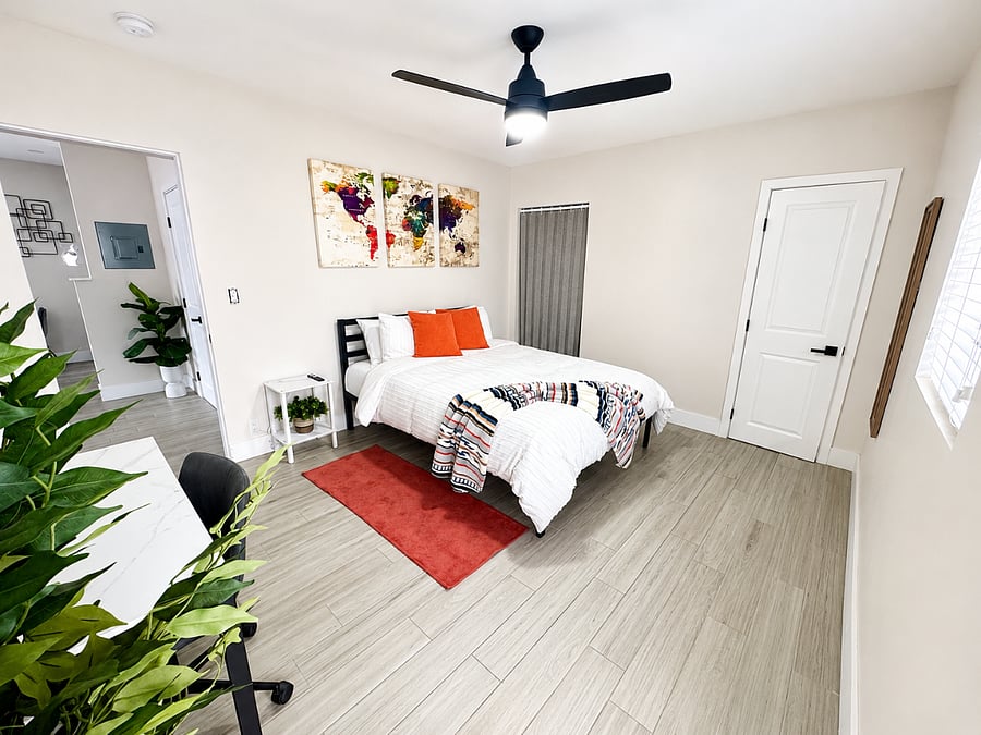 Bedroom with ensuite bathroom and exterior exit door