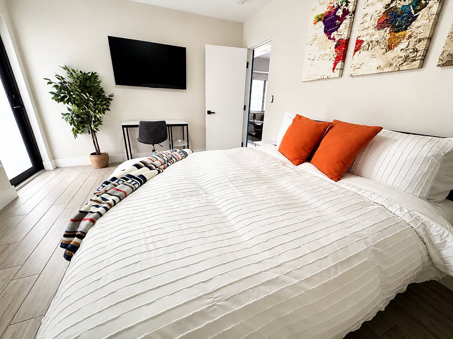Bedroom with ensuite bathroom and exterior exit door