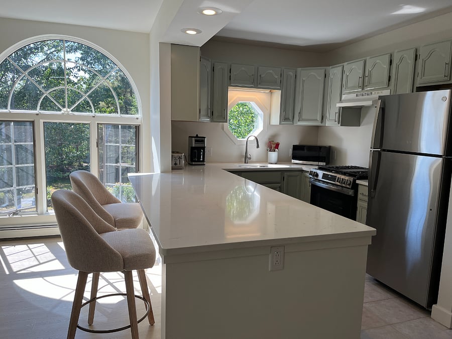 Comfortable new swivel counter stools at new kitchen quartz countertop.