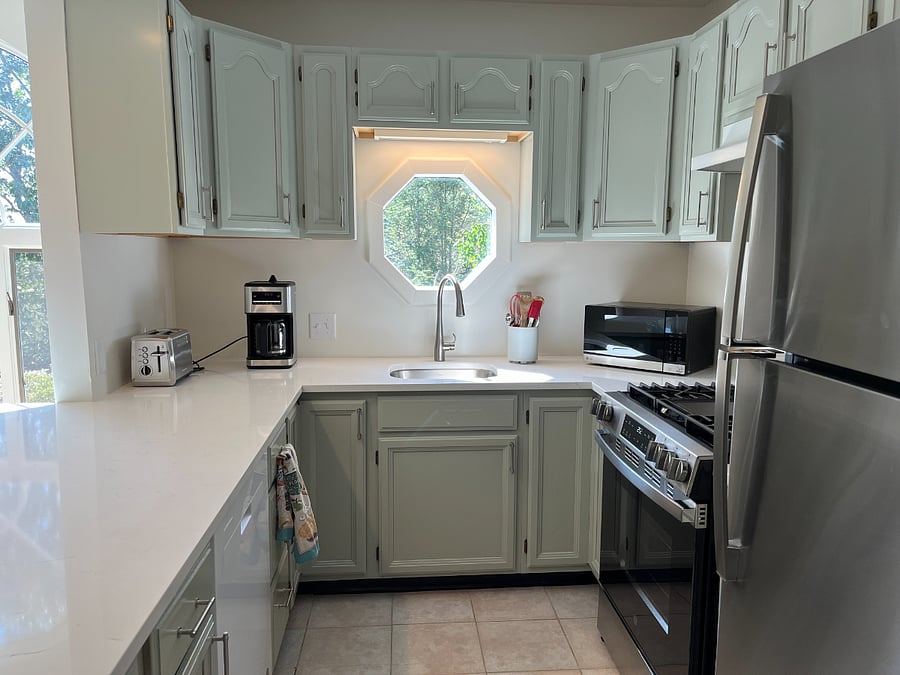 New gas stove, exhaust fan and refrigerator. 