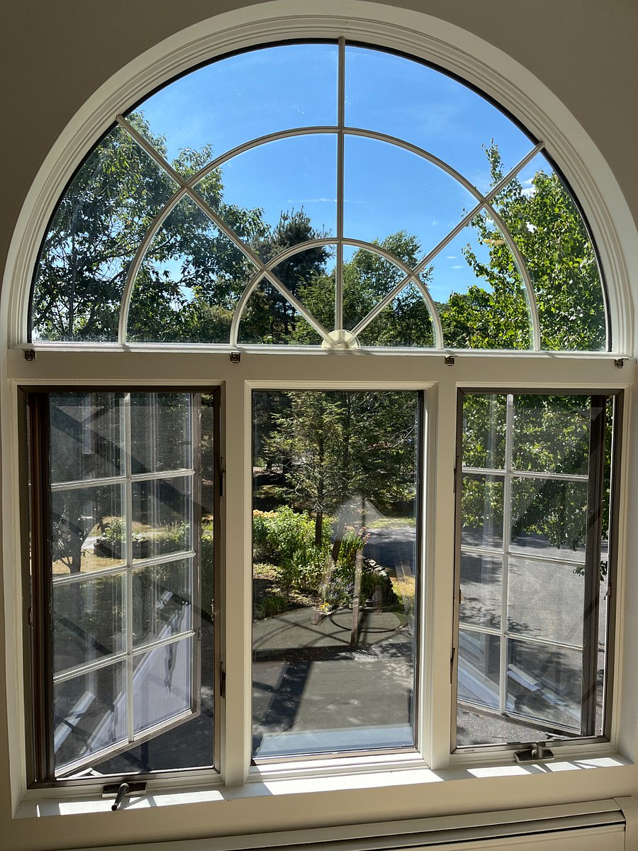Palladian window in open concept living/dining/kitchen overlooks gardens and is southwest facing.