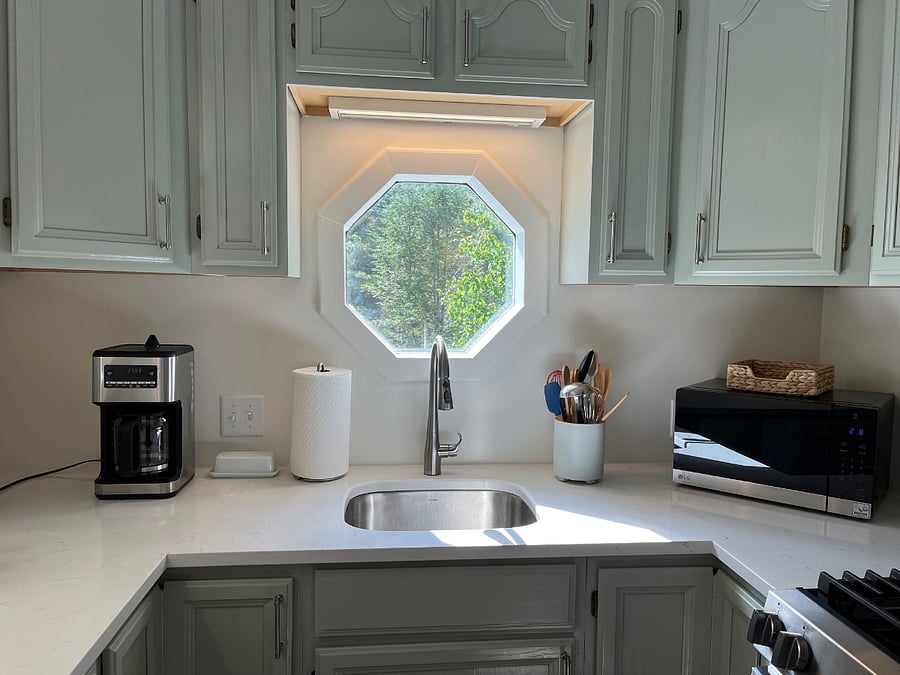 New stainless steel kitchen under mount sink, single handle faucet and garbage disposal.