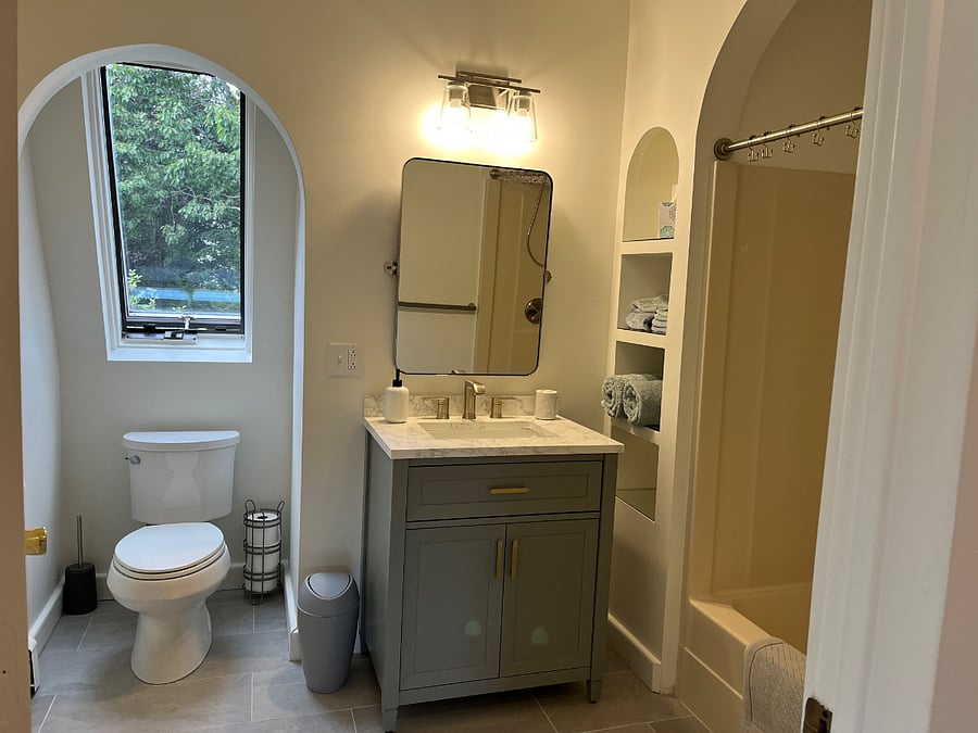 Newly renovated bathroom includes porcelain floor tile, new vanity and sink; all fixtures. Full tub and shower. 