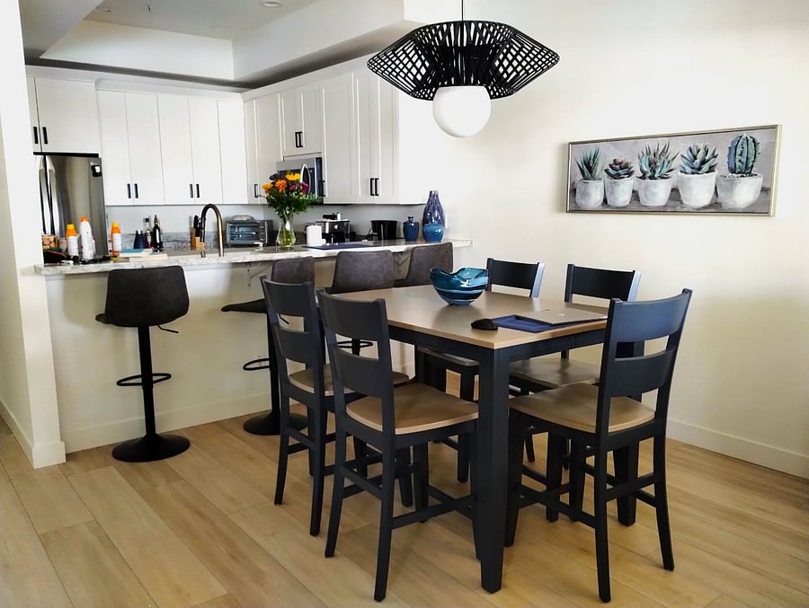 Dining area includes high table and six chairs. There is a table leaf in the closet and four bar chairs that make entertaining ten people a delight.