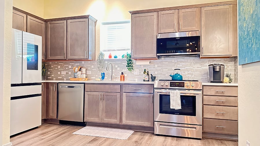 Open kitchen is well lit from several sources, and features all major kitchen appliances:  Full sized refrigerator, stove, oven, microwave, dishwasher.  Coffee station includes a Kuereg or a Nespresso (guest choice) and a starter pack of pods.  Smart Samsung fridge features a auto-refill water pitcher (our favorite feature).
