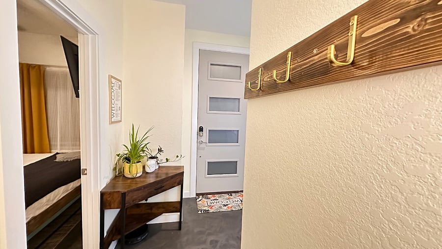 The "drop zone" between the front door and the garage door features a desk with drawer of umbrellas and extra floor mats, hooks to hang your bags, keys and backpacks, and a sunglasses station to help your group remember to always protect your eyes in the bright Texas sunshine!  A simple robot vacuum lives under the desk and is ready to help you keep floors tidy on a regular basis.  
