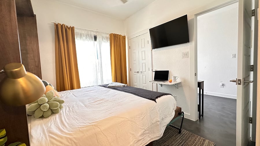 Open King murphy bed features a medium-firm mattress and 100% cotton sheets.  Pillows tuck away on side shelves when the bed is folded away for office use.
