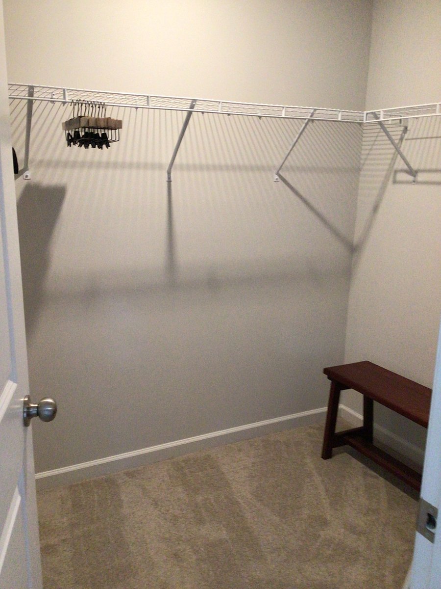 Walk in closet has plenty of storage