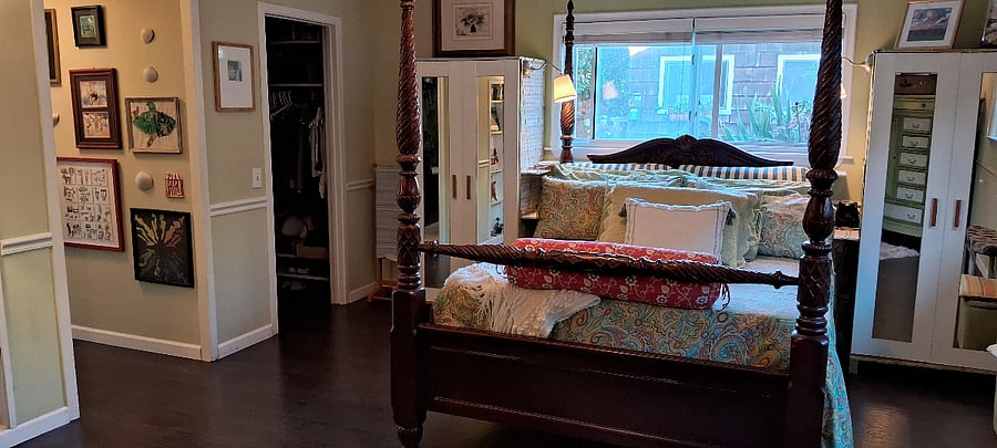 Primary bedroom in seperate wing- lots of natural light. Queen size, 4-poster bed, ensuite bathrooom, walk-in closet, tons of storage.