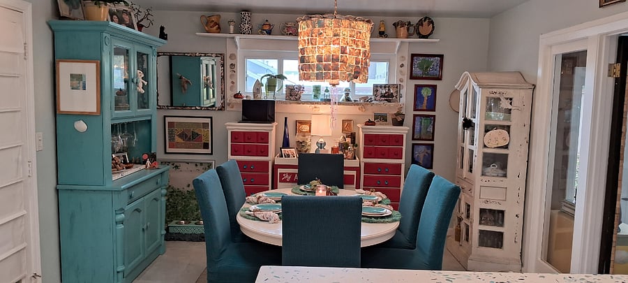 Dining room, off the kitchen. Table seats 6, but can be reduced to 4, if desired. Handmade custom shell chandelier! 2 sets of dishes to use. Lots of colorful linens! Make dinners special here at the beach!