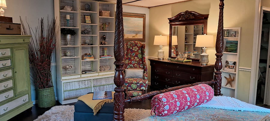 This is the other end of the primary bedrm. Custom painted dresser and custom-upholstered unique, vintage wingback chair. TONS of storage in 2 wardrobes, 2 large dressers and a full walk-in closet mean you can bring ALL your clothes!