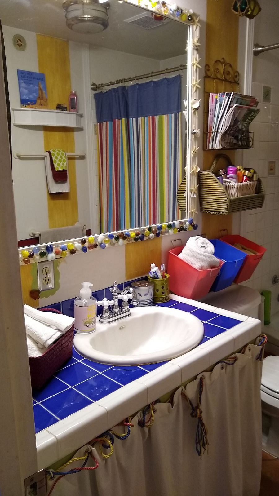 This is the second bathroom, which is right across from the 2nd and 3rd bathroom, It features a gorgeous custom mirror, lots of shells from Miramar Beach, and a full bath and shower.